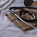 A stethoscope and blood pressure cuff on a white surface, symbolizing healthcare equipment.
